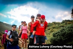 The older kids hike to camp along a gently sloping mountain path.