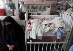 Newborns who lost their mothers during a May 13 attack lie on a bed at a hospital in Kabul.