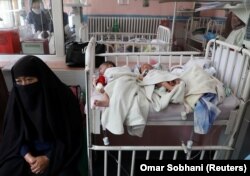 Newborns who lost their mothers during a May 13 attack lie on a bed at a hospital in Kabul.