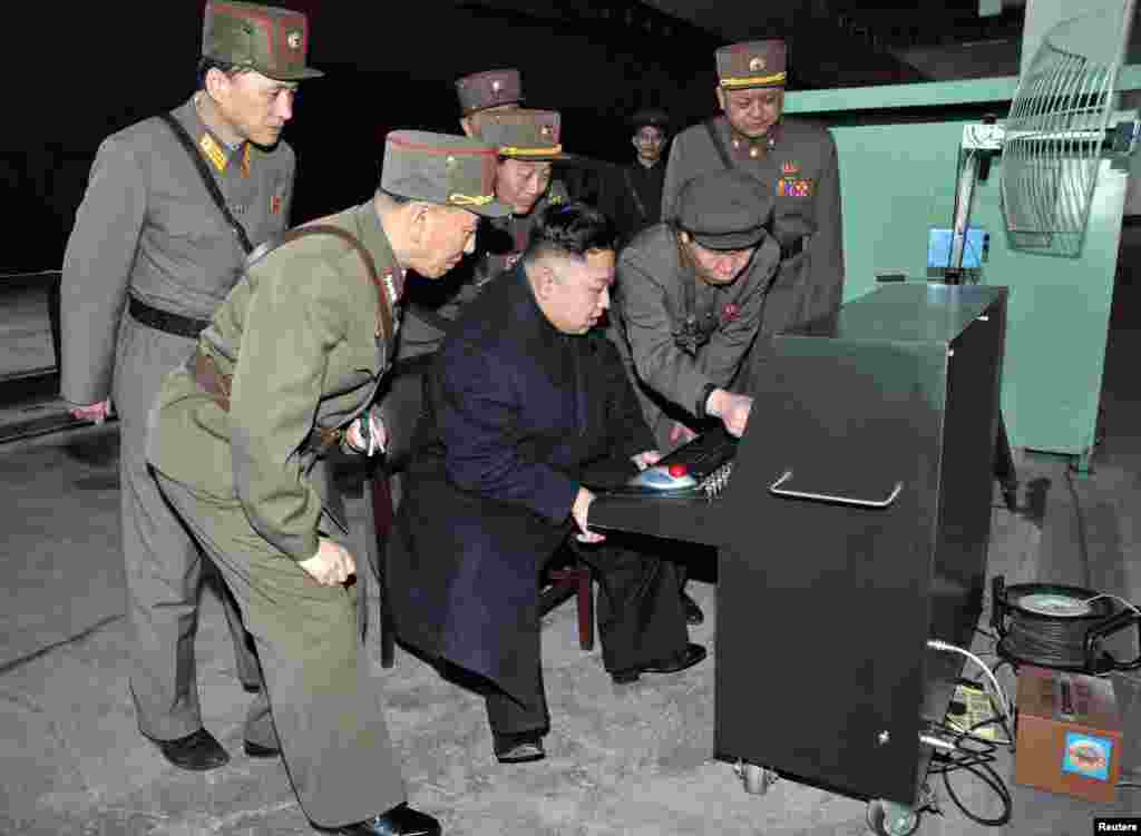 North Korean leader Kim Jong Un (center) looks at the latest combat and technical equipment made by Unit 1501 of the Korean People&#39;s Army during a visit to the unit. (Reuters/KCNA)