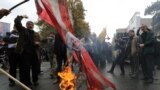 Iranians burn U.S. flags outside the former U.S. Embassy in Tehran on&nbsp;November 4, 2014.
