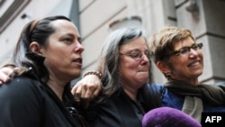 Cindy Hickey, Nora Shourd, and Laura Fattal (left to right), mothers of the three Americans being held in Iran, speak to the media before leaving New York on May 18 to visit their captive children.