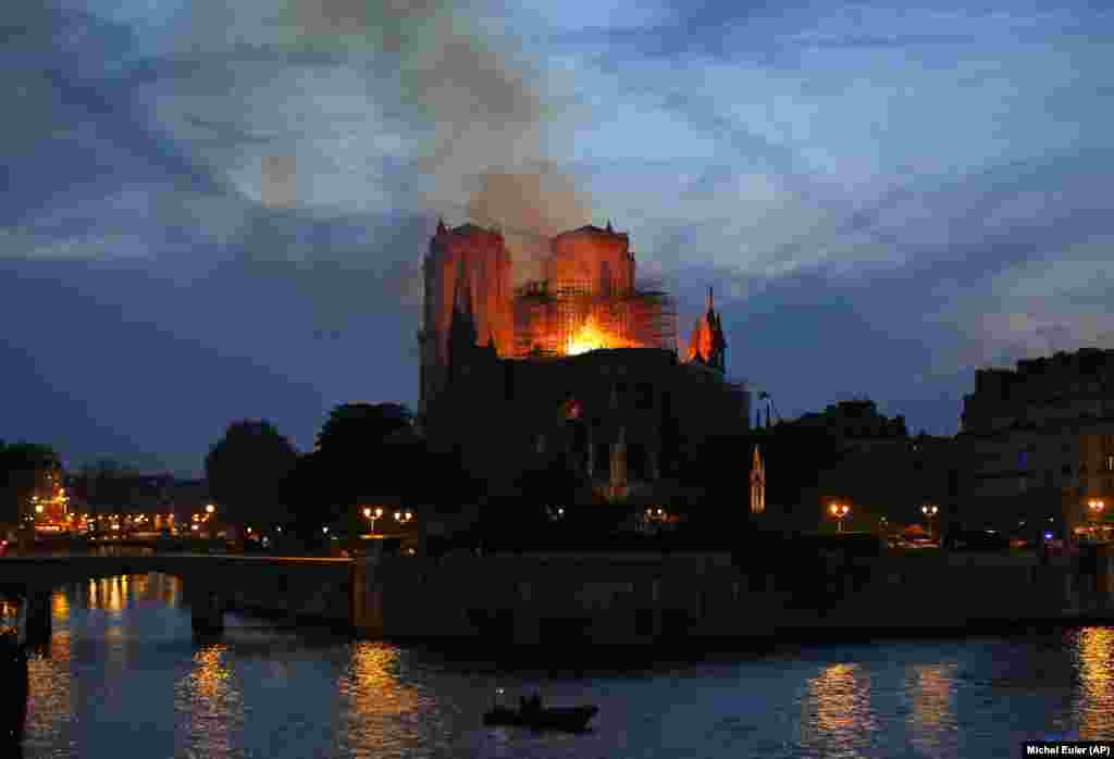 Firefighters tackle the blaze as flames and smoke rise from the Notre Dame Cathedral as it burns in Paris on April 15.&nbsp;(AP/Michel Euler)&nbsp;