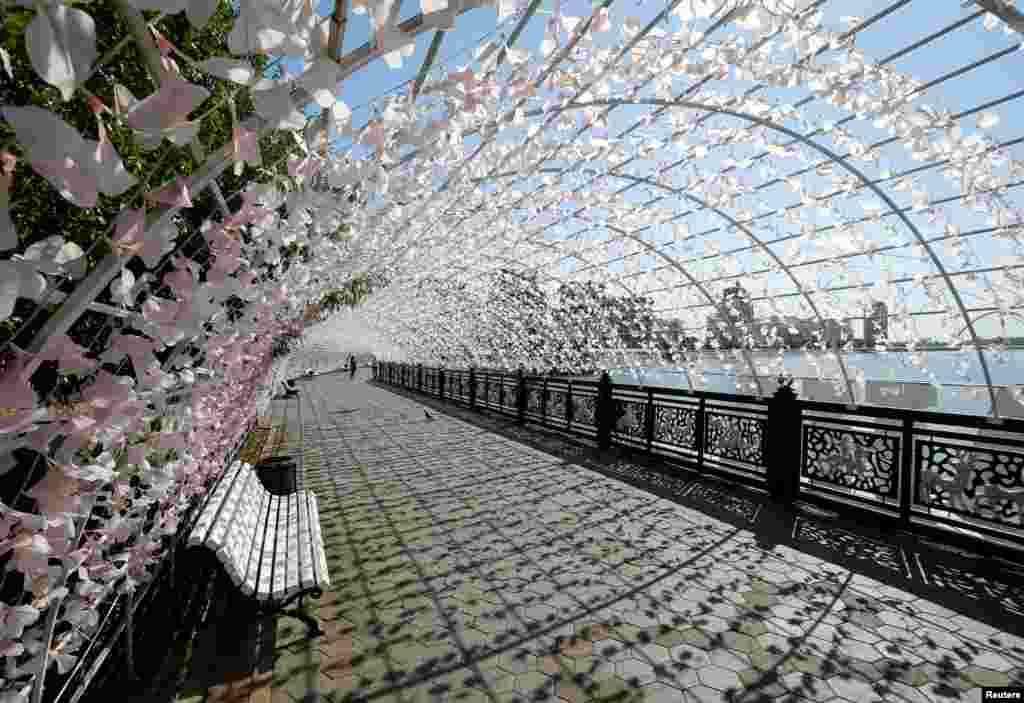 Women walk along the decorated embankment of the Ishim River in Astana, Kazakhstan. (Reuters/Shamil Zhumatov)