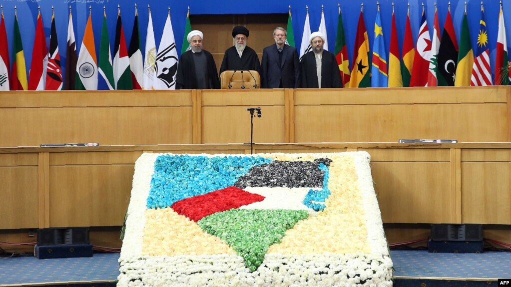 Iranian President Hassan Rohani (left to right), Supreme Leader Ayatollah Ali Khamenei, parliament speaker Ali Larijani, and judiciary chief Sadeq Larijani attend an international conference in support of the Palestinian intifada in Tehran on February 21.