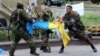 Проросійські бойовики з батьйону «Восток» розривають український прапор, Донецьк, 29 травня 2014 року