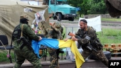 Pro-Russian fighters of the Vostok (East) Battalion rip apart a Ukrainian flag outside the regional administration building in the eastern city of Donetsk, on May 29.