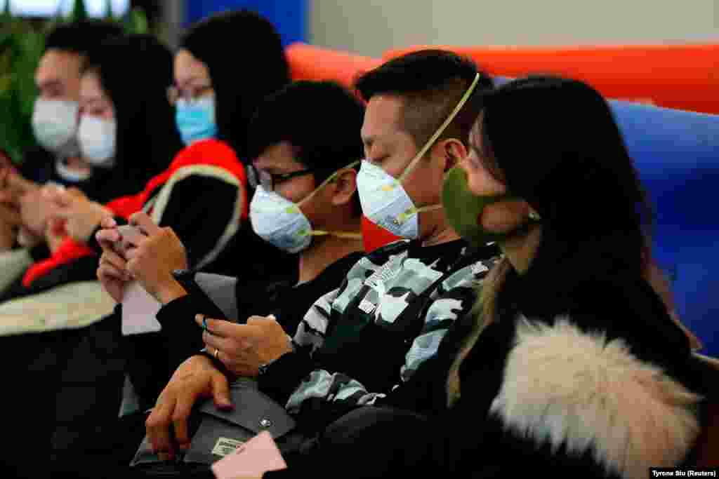 Passengers wear masks to prevent an outbreak of a new coronavirus at the Hong Kong West Kowloon High Speed Train Station, in Hong Kong on January 23, 2020.