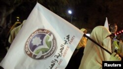 Supporters of the Muslim Brotherhood march ahead of parliamentary elections.