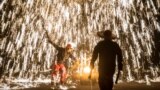 CHINA -- Artists perform with molten metal to create sparks like fireworks during the 'Molten Metal Sparks (Datiehua)' show, near Badaling Great Wall, in Yanqing district of Beijing, February 7, 2019