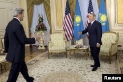 U.S. Secretary of State John Kerry (left) is greeted by Kazakh President Nursultan Nazarbaev before meeting at the Presidential Palace in Astana on November 2.