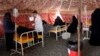 Yemenis suspected of being infected with cholera receive treatment at a makeshift hospital in Sanaa. 