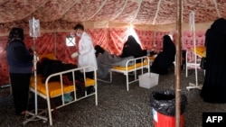 Yemenis suspected of being infected with cholera receive treatment at a makeshift hospital in Sanaa.