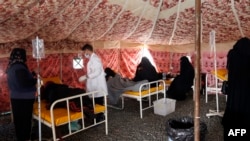 Yemenis suspected of being infected with cholera receive treatment at a makeshift hospital in Sanaa (file photo)