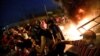 Demonstrators defy a curfew two days after the nationwide anti-government protests turned violent, in Baghdad on October 3.