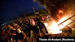 Demonstrators defy a curfew, two days after the nationwide anti-government protests turned violent, in Baghdad, October 3, 2019