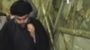 Shi'ite cleric Muqtada al-Sadr visits the Imam Ali shrine on his return to Iraq, in Al-Najaf, on January 5.