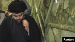 Shi'ite cleric Muqtada al-Sadr visits the Imam Ali shrine on his return to Iraq, in Al-Najaf, on January 5.