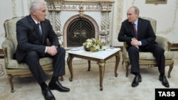 The de facto president of the breakaway region of South Ossetia, Leonid Tibilov (left), at a meeting with Russian President Vladimir Putin outside Moscow in October 2012