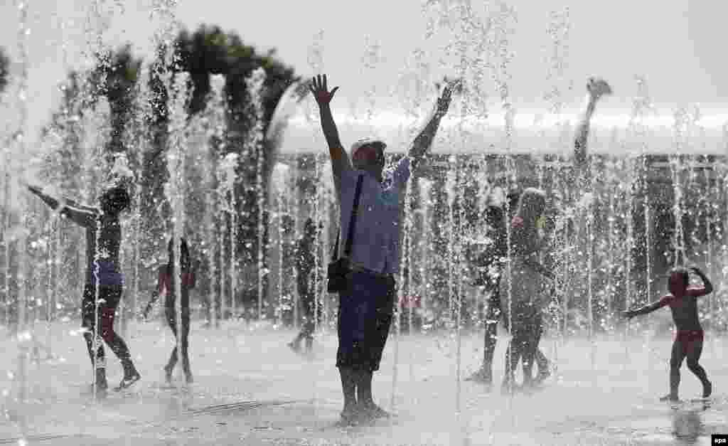 Muscovites cool off at a public fountain during a hot summer day in the Russian capital on July 28. (epa/Yury Kochetkov)
