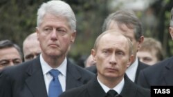 Former U.S. President Bill Clinton (left) and Russian President Vladimir Putin attend the funeral of Putin's predecessor, Boris Yeltsin, in Moscow in April 2007.