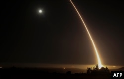 A streak of light trails off into the night sky after the U.S. military test-fired an unarmed intercontinental ballistic missile at Vandenberg Air Force Base, some 200 kilometers northwest of Los Angeles, in May 2017.