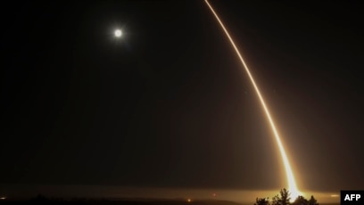 A streak of light trails off into the night sky as the U.S. military test-fires an unarmed intercontinental ballistic missile at Vandenberg Air Force Base, northwest of Los Angeles, California, in 2017.