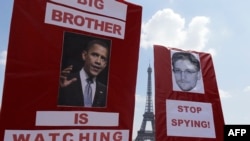 Demonstrators in support of Edward Snowden rally in Paris on July 7.