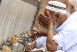 A man performs wudu (ablution) before Friday Prayers in Peshawar during the Muslim holy month of Ramadan amid the coronavirus lockdown in Khyber Pakhtunkhwa Province.