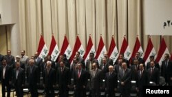 Iraq's new government stands for an oath at the house of parliament in Baghdad on December 21.