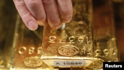 Бундесбанктын кызматкери Франкфурттагы маалымат жыйынында алтынды текшерүүдөн өткөрүү процессин көрсөттү, 16-январь, 2013