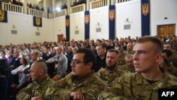 Delegates of the new Ukrainian far-right political party "National Corps" sing the national anthem.