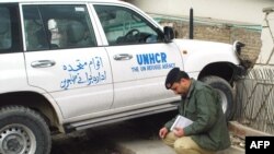 A police officer inspects the site where John Solecki was kidnapped in Quetta.