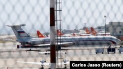 An airplane with the Russian flag is seen at Simon Bolivar International Airport in Caracas on March 24.