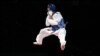 Afghanistan&#39;s Rohullah Nekpa jumps in celebration after winning his men&#39;s 68-kilogram bronze medal taekwondo match against Britain&#39;s Martin Stamper at the London Olympics. (Reuters/Darren Staples)