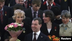 Russian President Dmitry Medvedev (center) poses with Russian Olympians after an awards ceremony in the Kremlin on March 15.