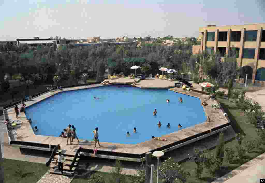 An octagonal swimming pool at the guest house of the Iranian National Oil Company that provides relief when the temperatures rise above 100 degrees is seen near Ahwaz, Iran, July 1971. (AP Photo/Horst Faas)