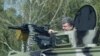 Ukrainian President Petro Poroshenko tries out a tank on July 26.