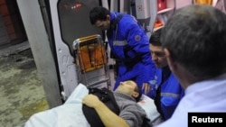 Russia -- Medics wheel a victim of a bomb explosion at Domodedovo airport from an emergency vehicle into the N.V. Sklifosovsky Scientific Research Institute of First Aid in Moscow, 24Jan2011