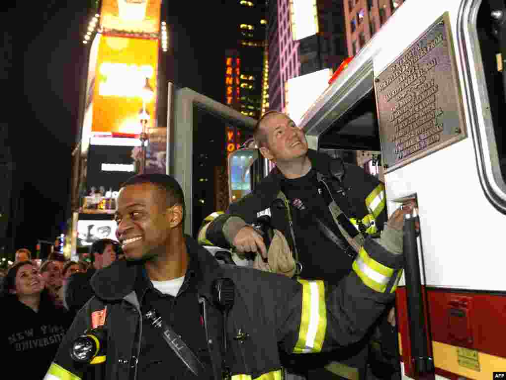 New York City firefighters gather in Times Square to celebrate the announcement.