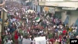 A video still shows Syrian antigovernment demonstrators during a protest in Idlib last week. 