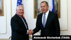 U.S. Secretary of State Rex Tillerson (left) and Russian Foreign Minister Sergei Lavrov meet on the sidelines of an annual session of the OSCE Council of Foreign Ministers in Vienna on December 7.