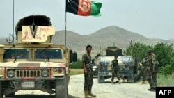 Afghan National Army (ANA) soldiers patrol the Shah Wali Kot district of Kandahar Province on May 23.