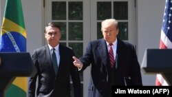 President Donald Trump take part in a joint press conference with Brazilian President Jair Bolsonaro in the Rose Garden at the White House in Washington, March 19, 2019