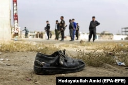 Afghan security officials inspect the scene of the suicide bomb attack in Kabul on October 31.