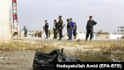 FILE: Afghan security officials inspect the scene of a suicide bomb attack in Kabul on October 31.