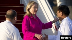 Deputy Foreign Minister Myo Myint (right) welcomes U.S. Secretary of State Hillary Clinton upon her arrival in Naypyitaw.