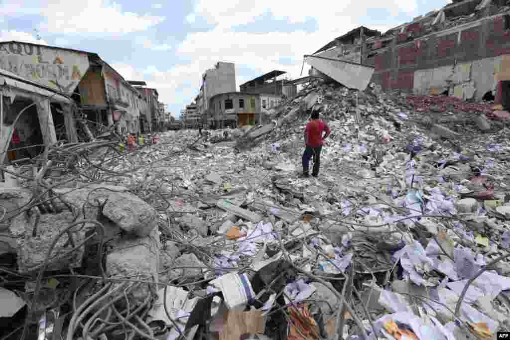 A man stares at the rubble in Portoviejo, Ecuador, after a 6.1-magnitude earthquake struck off the coast on April 20, sowing new panic four days after a more powerful quake killed more than 525 people, with hundreds still missing. (AFP/Juan Cevallos)