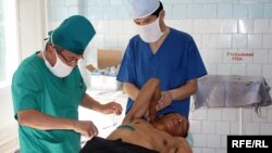 Doctors removing stitches from man with gunshot wounds following the ethnic violence in Osh in June.