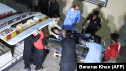 Pakistani medical workers transport an injured Shi'ite Muslim to a hospital in Quetta on September 10.